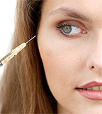 A woman prepares to receive a botox injection  (image©Rex Features )